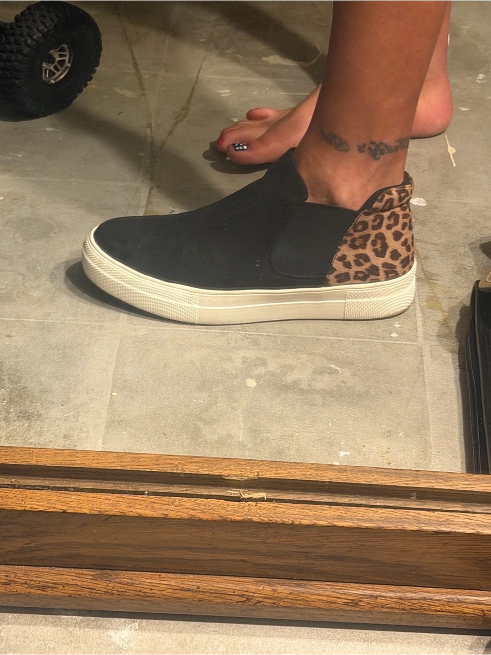 Soda Black Slip-On Sneaker with Leopard Heel Accent